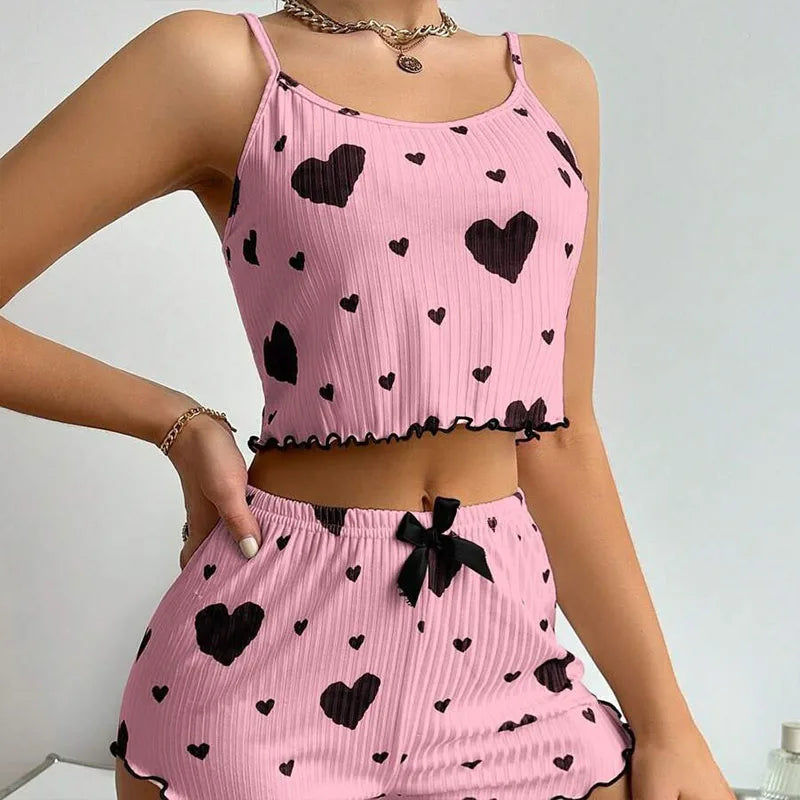 Pink outfit with black heart patterns on a plain background